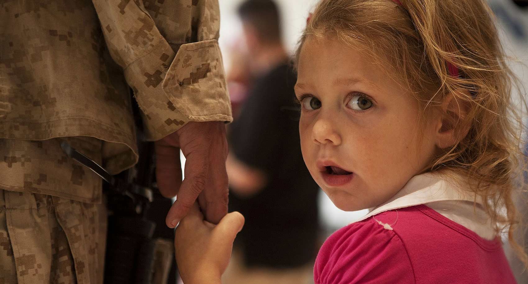 Girl holding soldiers hand